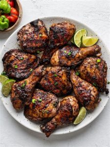 Several pieces of jerk chicken on a platter
